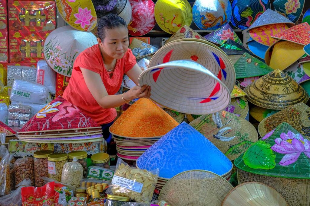 A local woman selling conical hats on Dong Ba Market