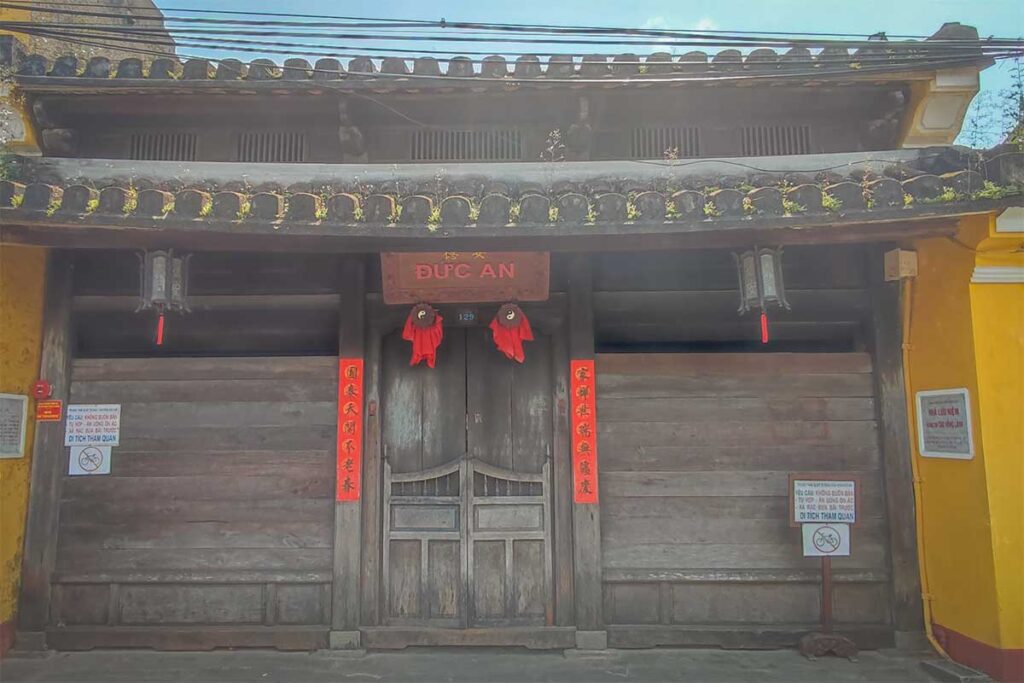 Full view of Duc An Old House exterior in Hoi An Ancient Town, showcasing its tiled roof, wooden façade, and historic architectural details.