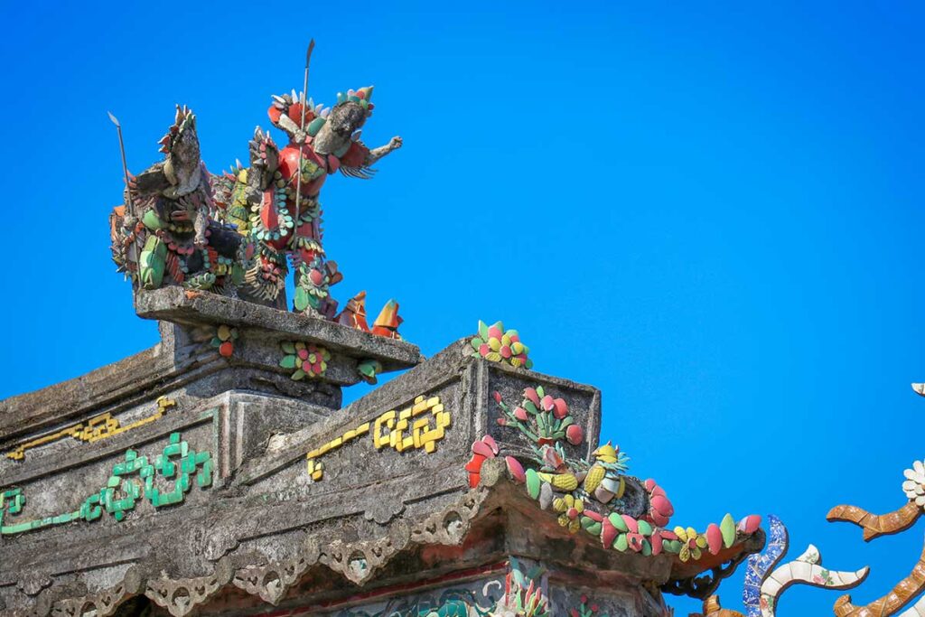 Close-up of roof figurines and decorative motifs at Phuc Kien Assembly Hall, Hoi An.