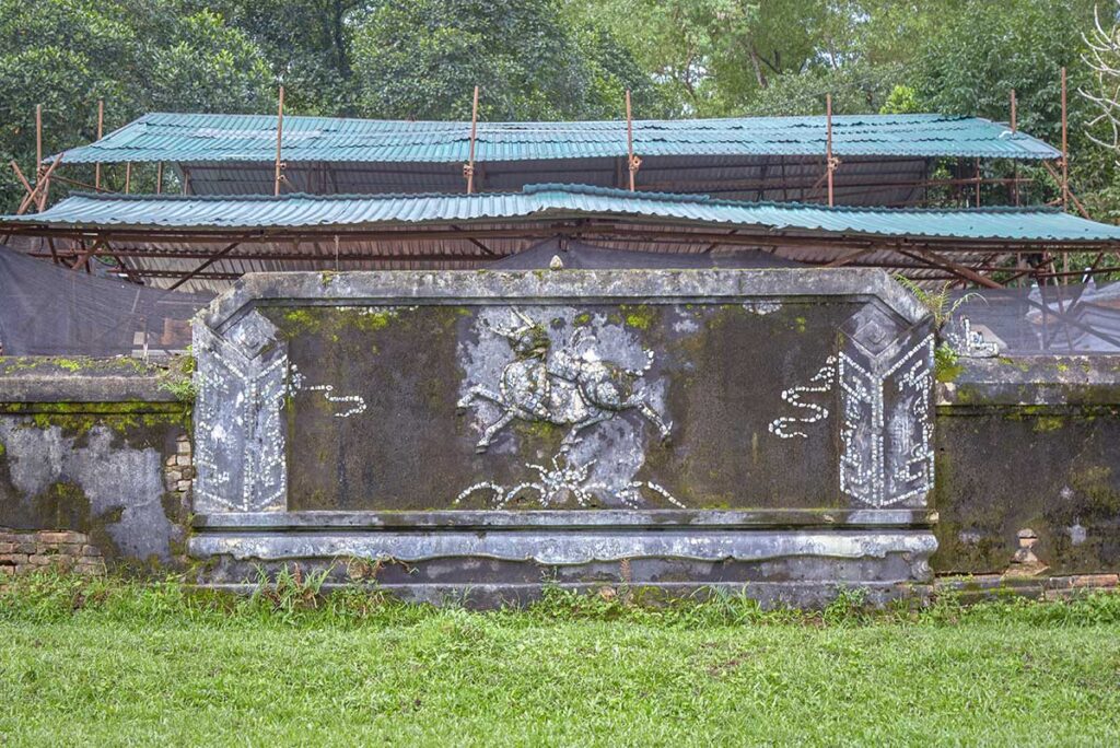 A stone plague of a bull with armor part of Ho Quyen Tiger Arena