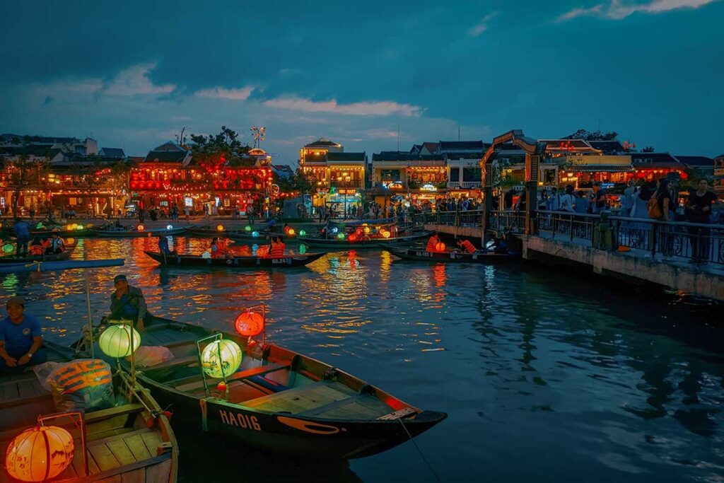 Lantern-lit boats on the Thu Bon River during an evening boat tour in Hoi An, Vietnam