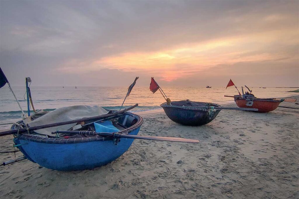 Traditional basket boats on Hidden Beach, Hoi An – Iconic round fishing boats resting on the sand of Hidden Beach at sunrise, ready for a day at sea.