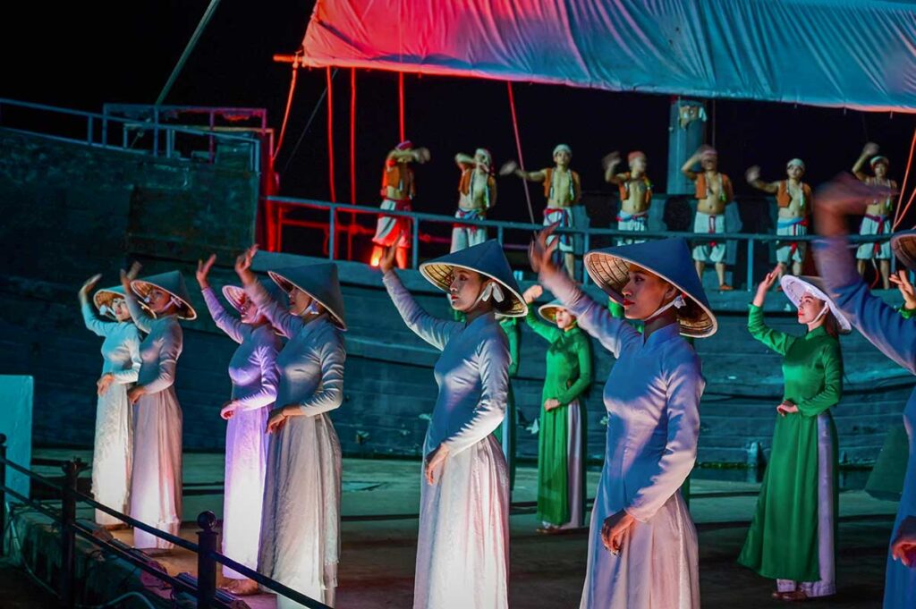 Performers in white and green ao dai during the Hoi An Memories Show at Hoi An Memories Land