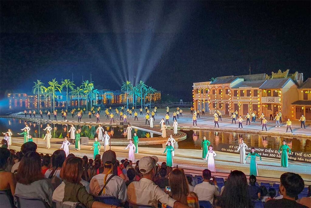 Large-scale performance with hundreds of dancers and light effects at the Hoi An Memories Show.