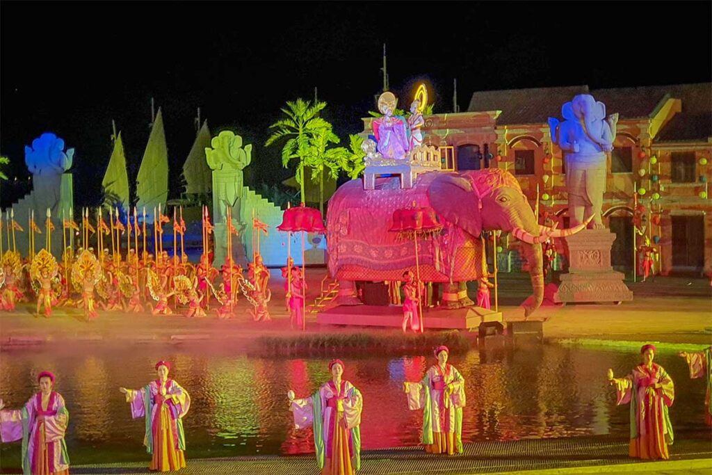 Historical scene with performers in royal costumes and a decorated elephant during the Hoi An Memories Show