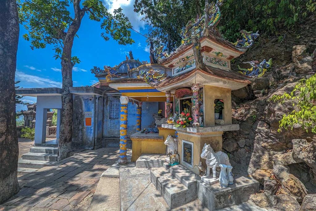 Small shrines next to a small praying hall part of Hon Chen Temple in Hue