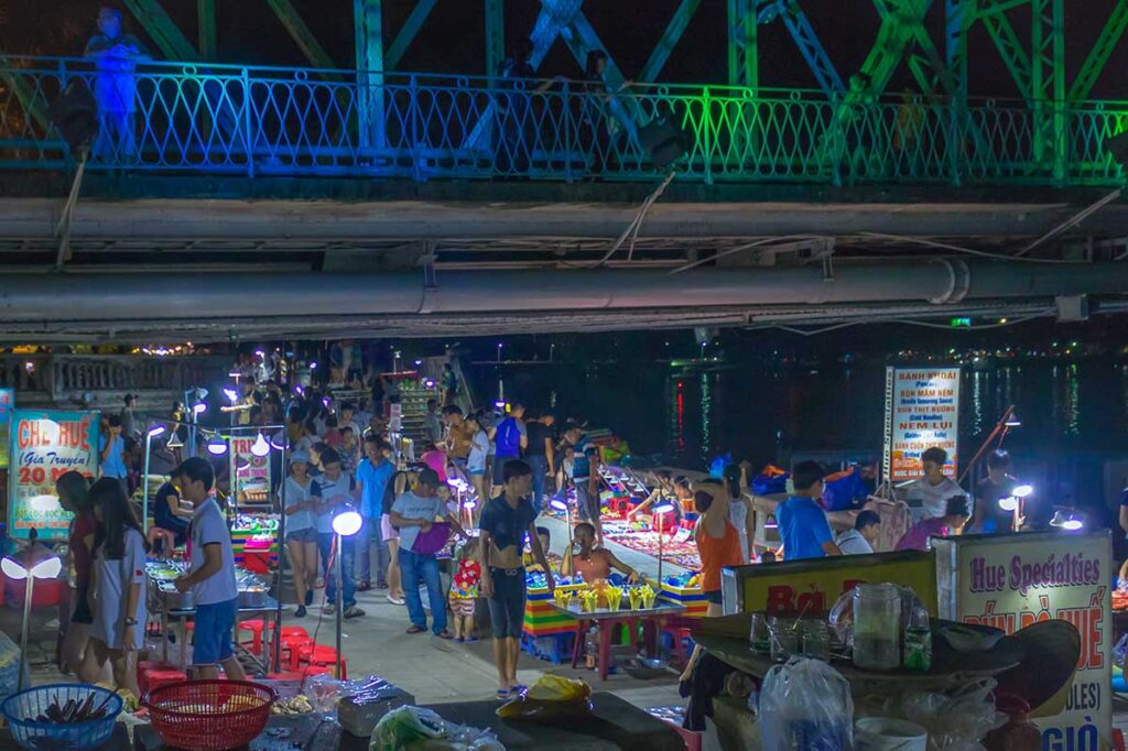 Hue night market with lots of locals below the bridge