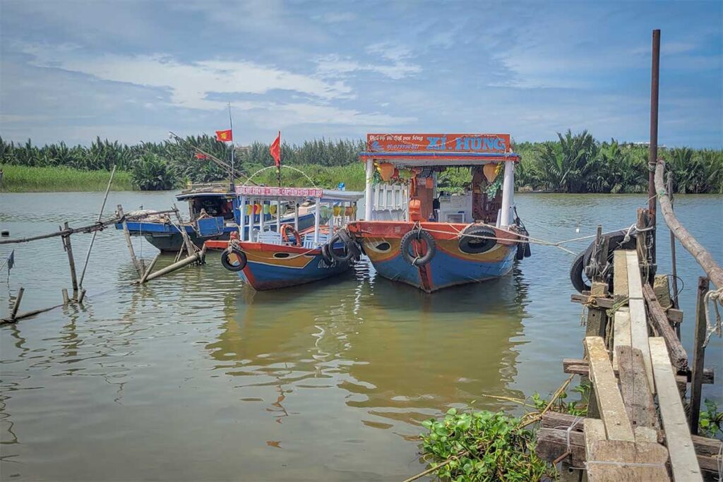 Wooden passenger boats docking at Kim Bong Carpentry Village pier on Cam Kim Island, Hoi An – main access point for visitors arriving by river.