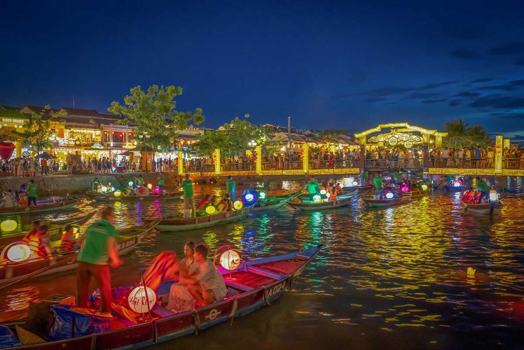 Colorful lantern boats on the river at night – the most iconic lantern boat ride in Hoi An Ancient Town.