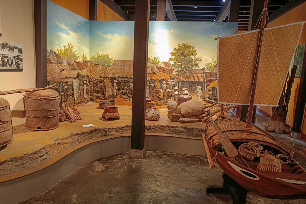 Exhibit at the Museum of Folk Culture in Hoi An Old Town showing traditional fishing tools, woven baskets, and village life displays.