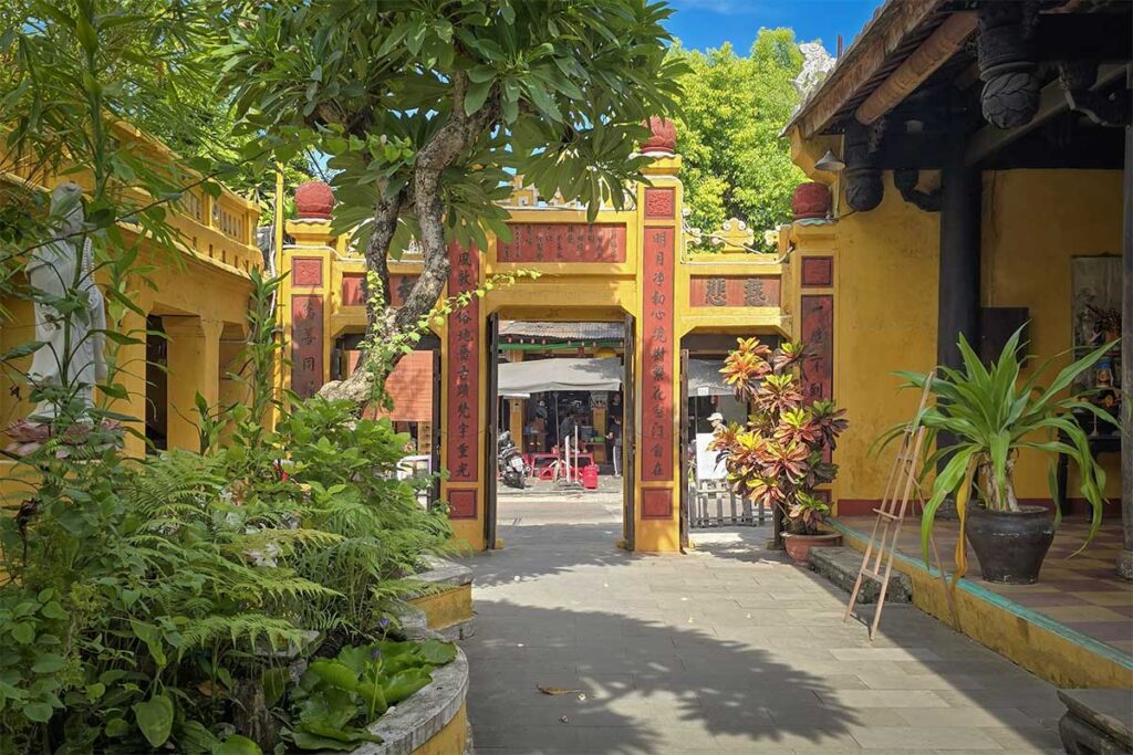 Peaceful courtyard and garden at Quan Am Pagoda, a must-see temple in Hoi An