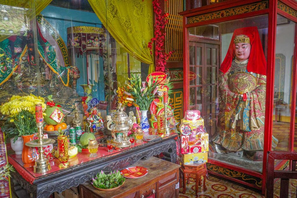 Quan Cong Temple Hoi An – altar with offerings and golden statue of the revered Chinese general