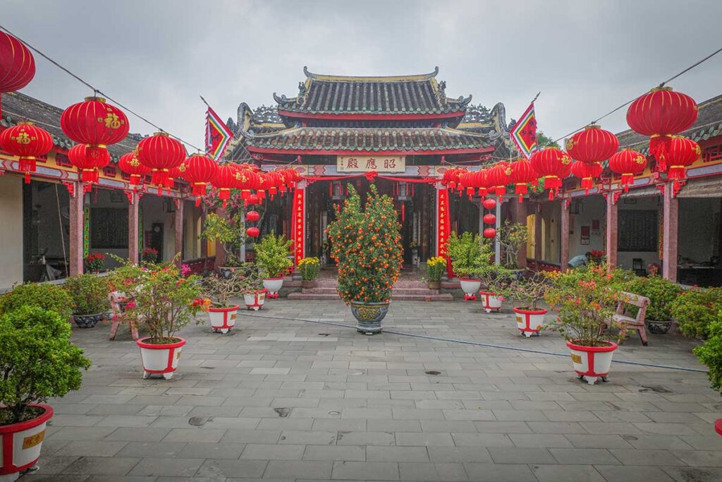 Quan Cong Temple in Hoi An Ancient Town, decorated with red lanterns and bonsai trees, dedicated to the Chinese general Quan Cong.