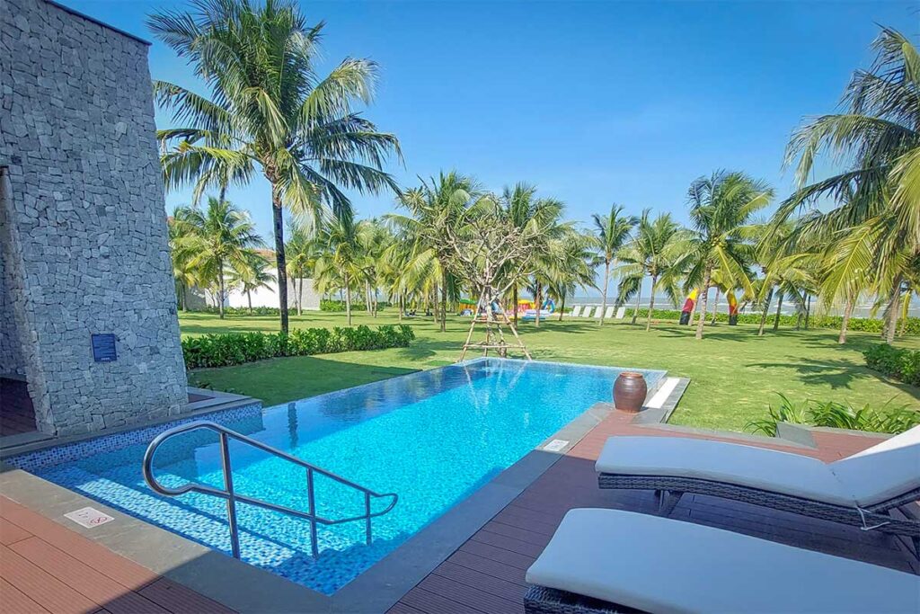 Private villa pool at Renaissance Hoi An Resort on Cua Dai Beach, overlooking palm gardens and the South China Sea.