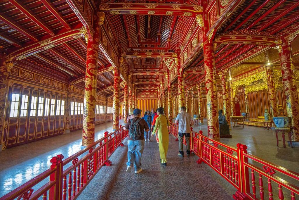 Tourists walking along the fenced path through Thai Hoa Palace