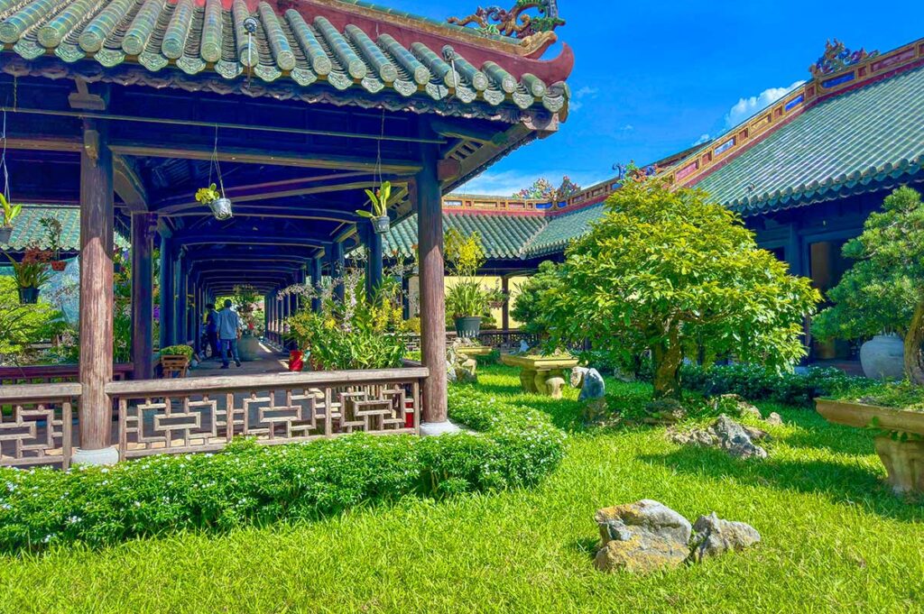 The Thieu Phuong Garden with a tiled walkway covered by a traditional wooden roof. within Forbidden Purple City of Hue