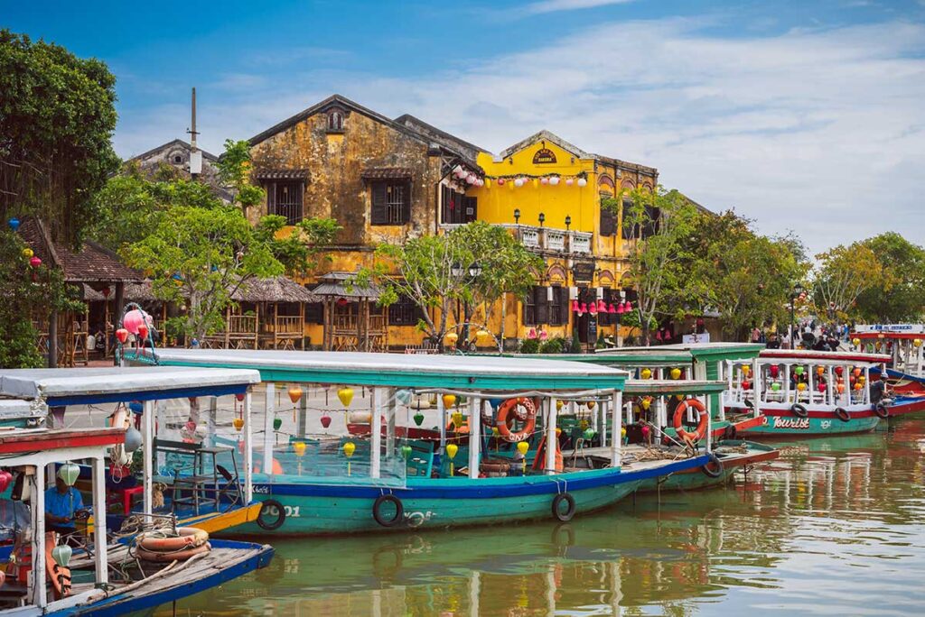 Passenger boat docked in Hoi An ancient town waiting for guest to take on a boat tour over the Thu Bon RIver