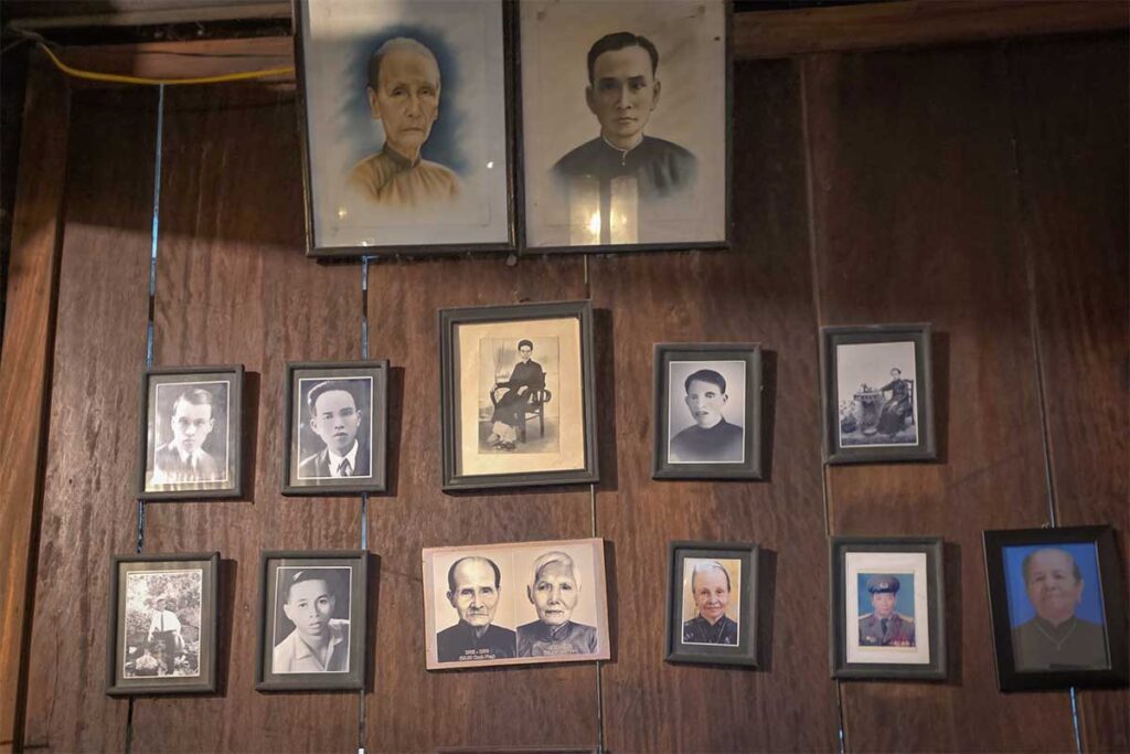 Historic portraits of Tran family ancestors displayed on wooden walls inside the Tran Family Chapel, Vietnam.