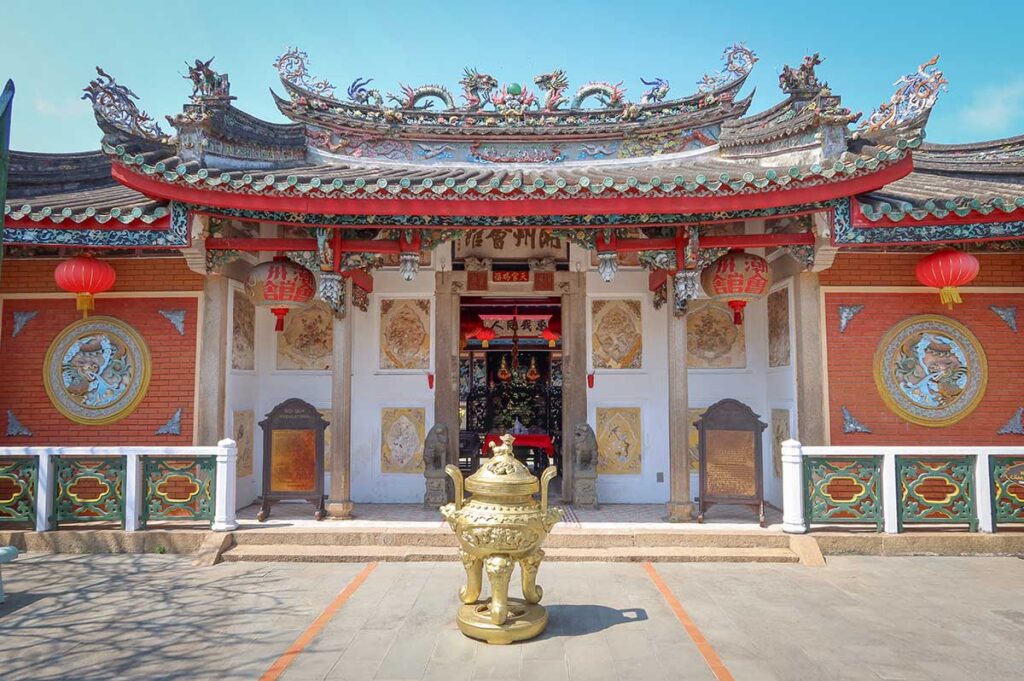 Main entrance of Trieu Chau Assembly Hall in Hoi An – Traditional Chinese architecture with dragon motifs, lanterns, and a large incense burner at the doorway.
