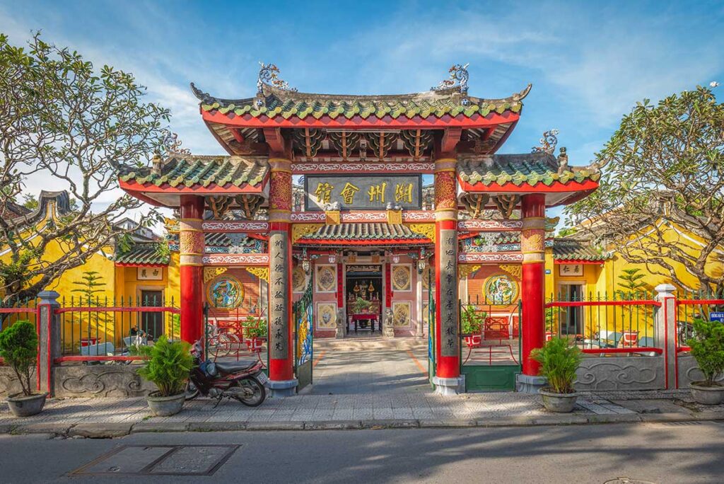 Front gate of Trieu Chau Assembly Hall in Hoi An Ancient Town – Bright red pillars, tiled roof, and Chinese calligraphy welcome visitors to this historic 19th-century hall.