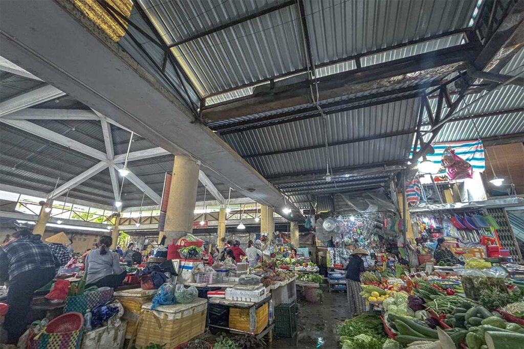 Inside Xep Market with fruit and vegetable stalls