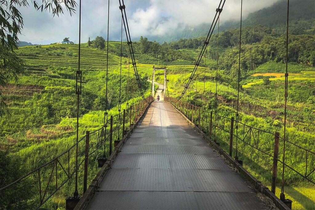 A steel bridge leading to Nam Dam Village