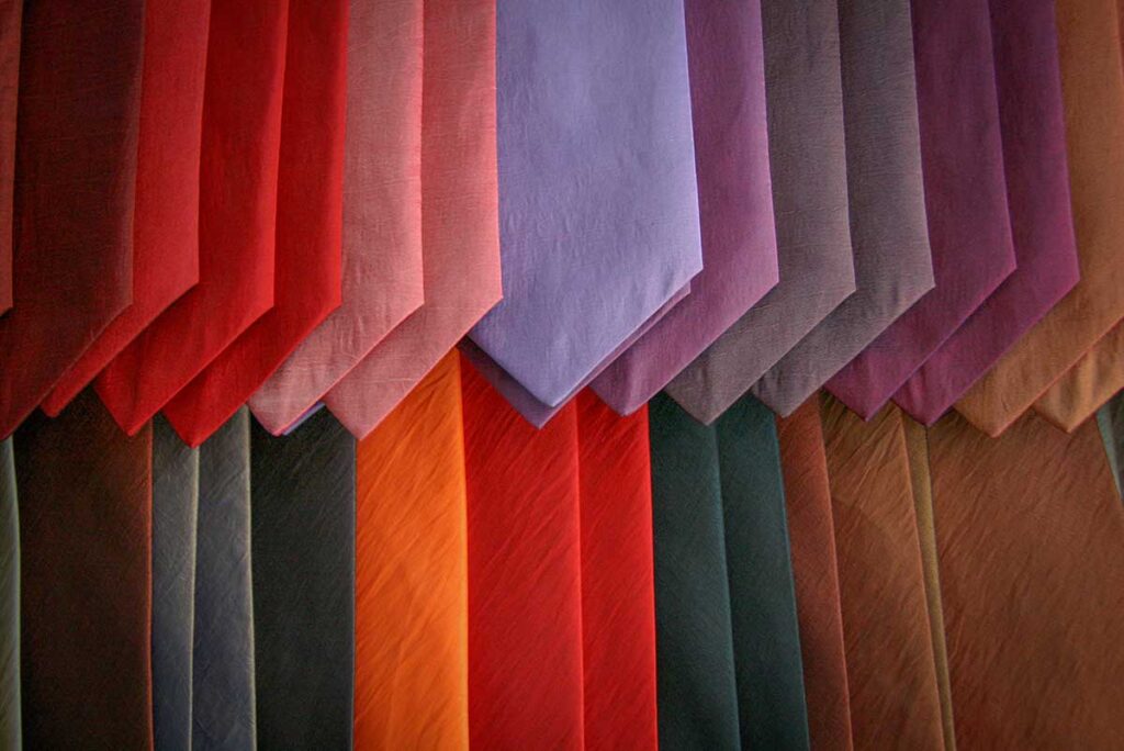 Elegant silk ties in vibrant colors displayed in a Hoi An boutique — popular souvenirs showcasing the city’s silk-making heritage