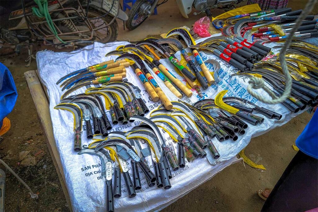 Sickle tools laying on a stall to be sold at the Lung Khau Nhin Market