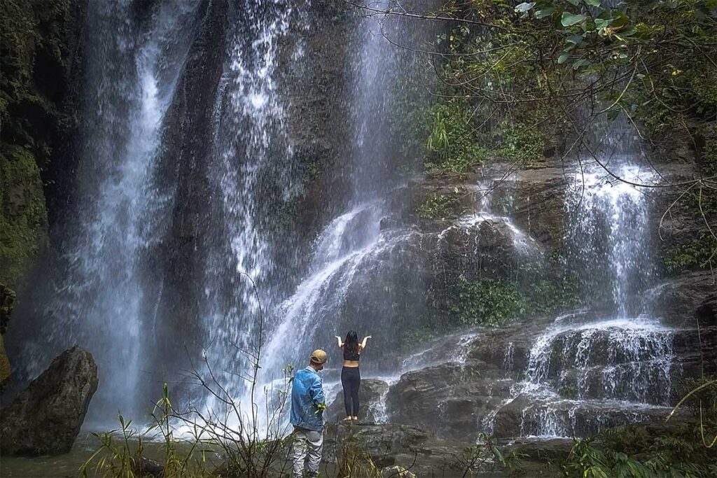 Two people standing Infront of Nai Nam Dam Waterfall