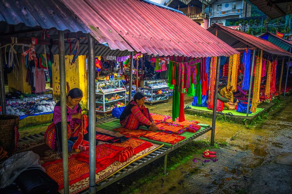 White Tay woman selling colorful clothes at Pa Co Market