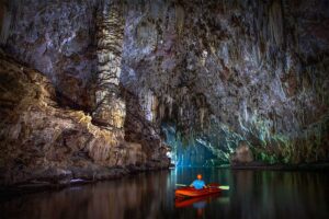 A man kayaking solo through Phong Nha Cave