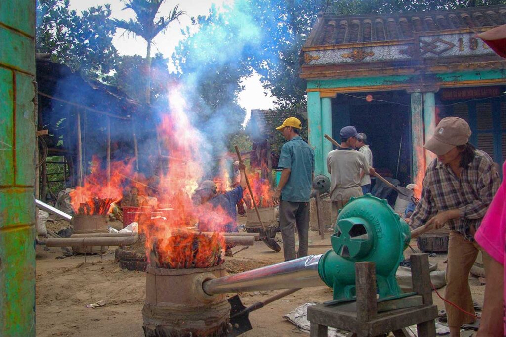 Bronze casting process with fire furnaces in action at Phuoc Kieu Bronze Casting Village, Vietnam.