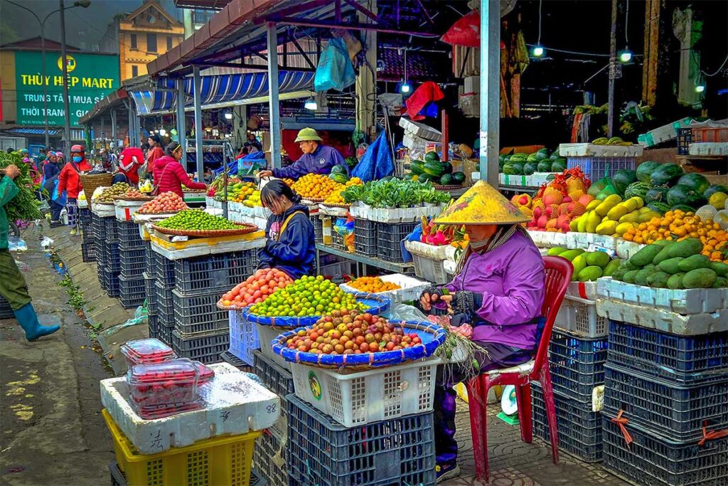 Vegetables, fruit and herbs being sold on small stalls outside the Sapa Market