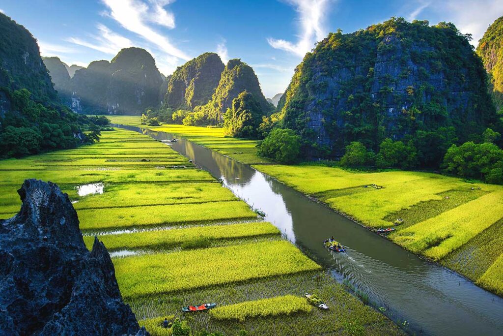 Aerial view of the river of Tam Coc where you can take a boat ride along the green rice fields