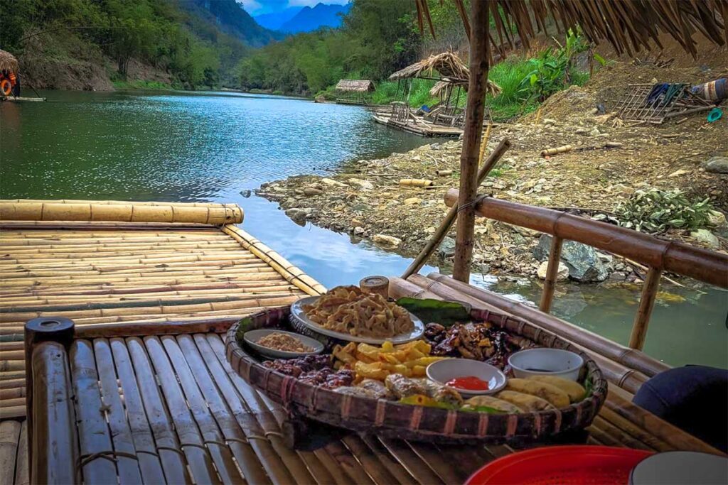 Lunch served on a table on a bamboo raft in Pu Luong
