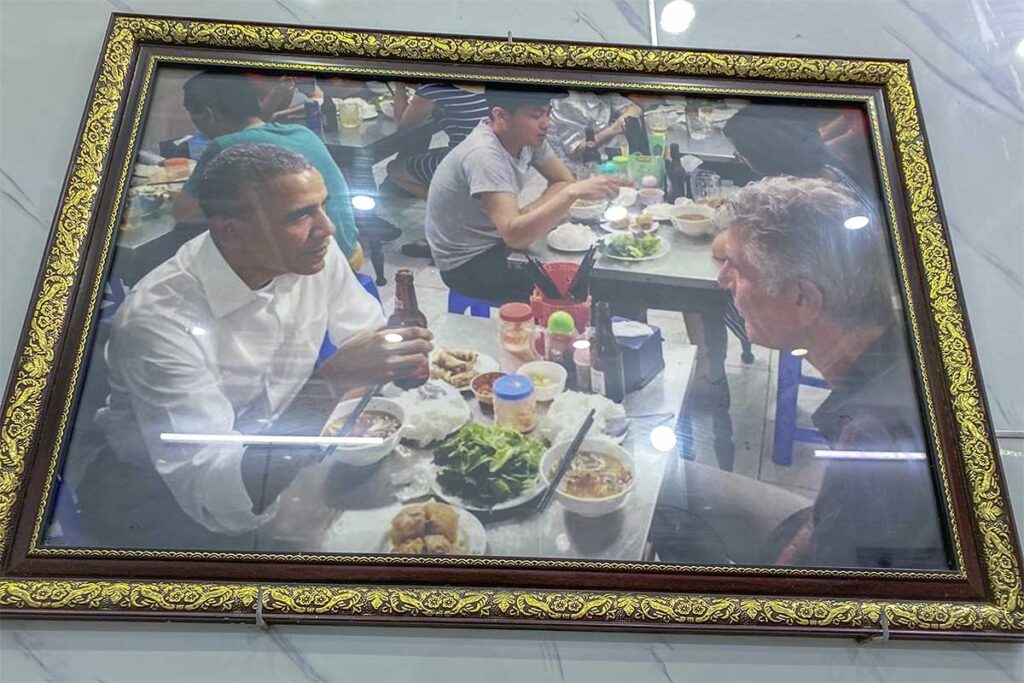 The famous picture framed on the wall of the restaurant Bun Cha Huong Lien of Anthony Bourdain and President Barack Obama eating at their restaurant