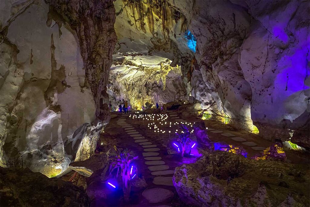 A cave called Holy Bird Cave (Chim Than Cave), lit with mystical lights that can be reached walking the famous Vietnam Glass Bridge