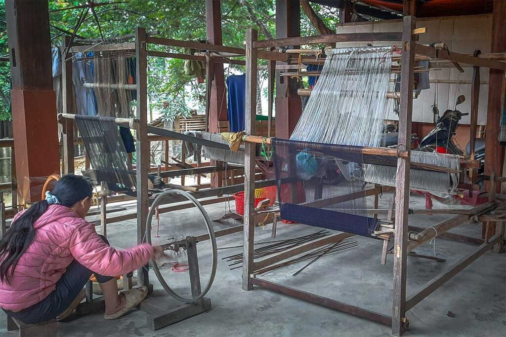 A local woman is weaving inside Nhot Village in Mai Chau