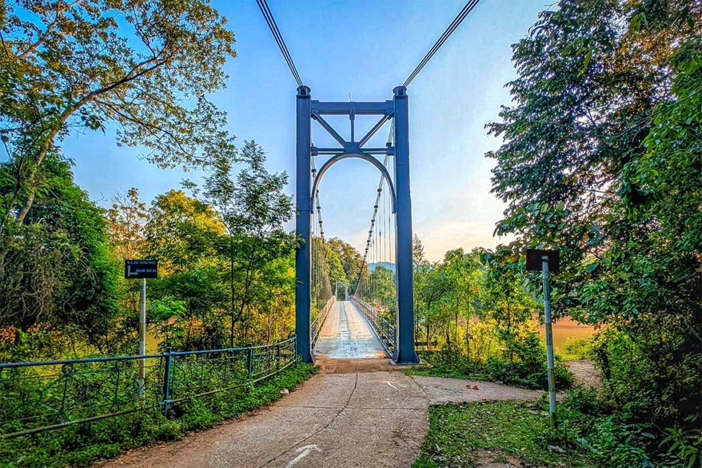 A scenic road with steel bridge crossing water at Pa Khoang Lake