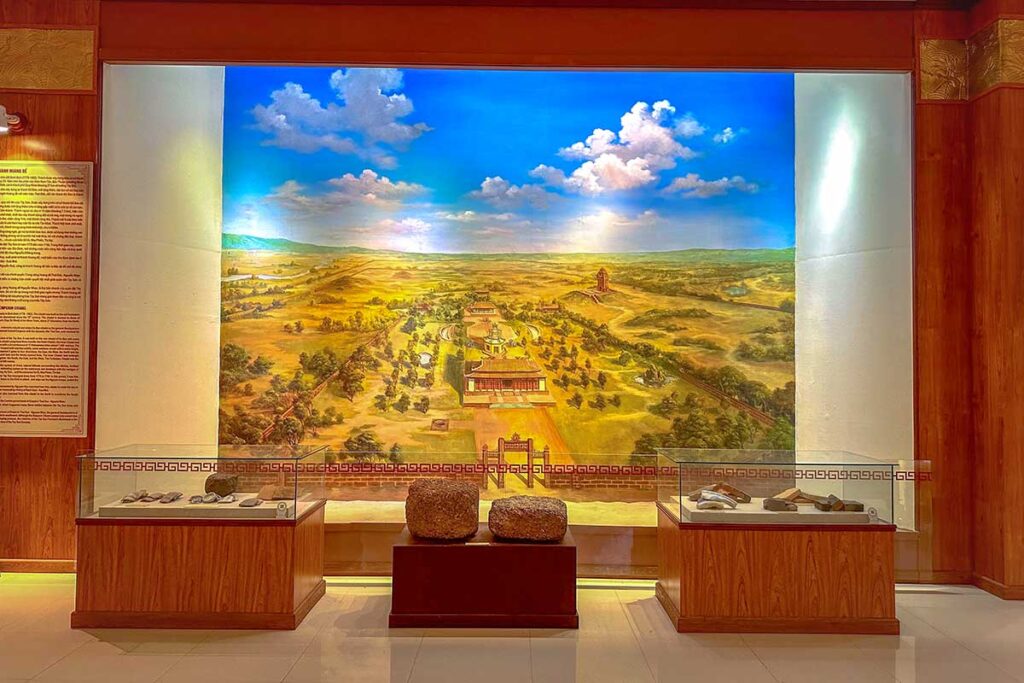 Panoramic mural inside Quang Trung Museum illustrating the Tay Son stronghold and surrounding landscape, alongside relics and artifacts.