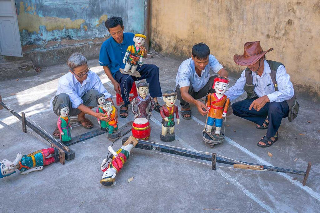 Local artists showing their water puppets on the street of Thanh Hai Water Puppet Village