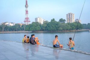 Kids fishing inside Thong Nhat Park in Hanoi
