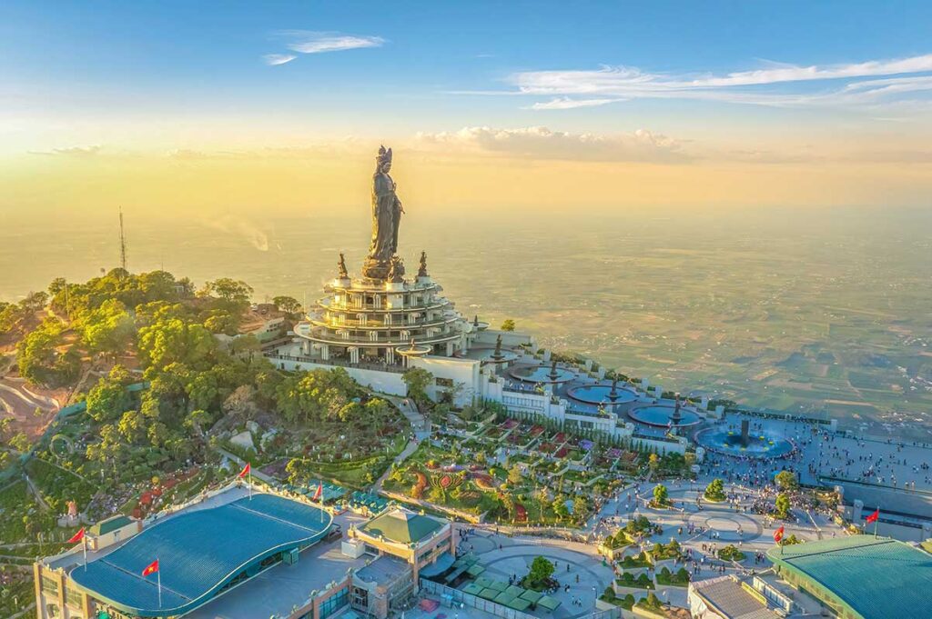 Aerial view of the complex with large statue at sunset of Black Virgin Mountain (Ba Den Mountain) in Tay Ninh