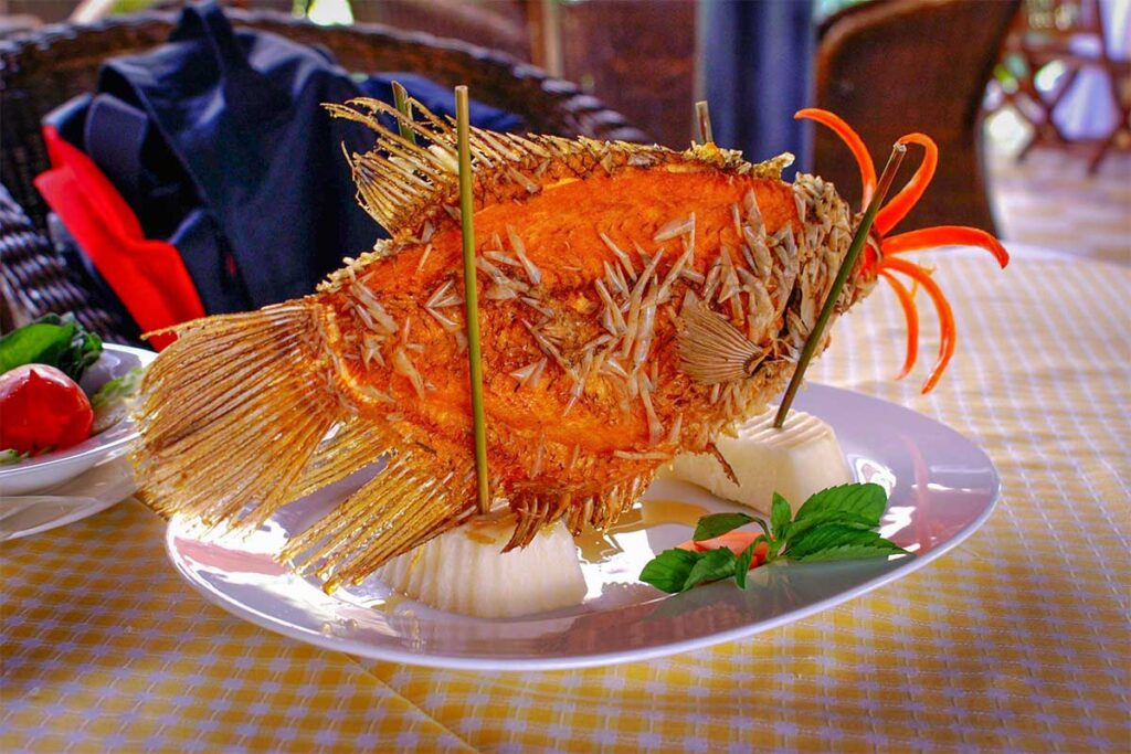 Fried elephant ear fish served in Cai Be, Mekong Delta – traditional local specialty dish often enjoyed at homestays and riverside restaurants.