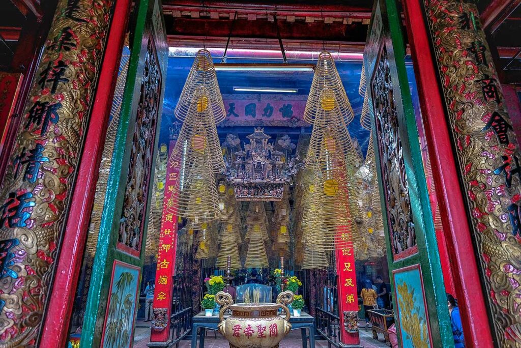 Entrance view of Ong Pagoda Can Tho showing hundreds of incense coils above the altar