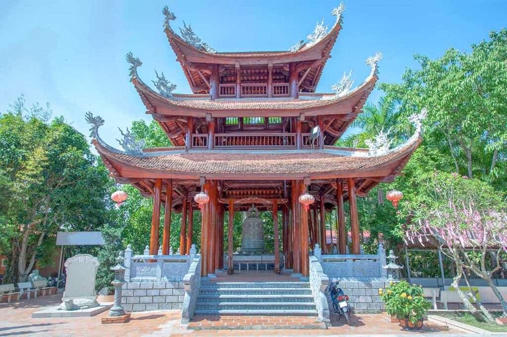 Bell tower at Truc Lam Phuong Nam Zen Monastery in Can Tho, featuring a large bronze bell and wooden architecture.