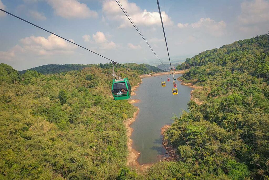 Cam Mountain cable car ride – Cable car line crossing over forest and lake on Cam Mountain, offering an easy way to reach the summit.