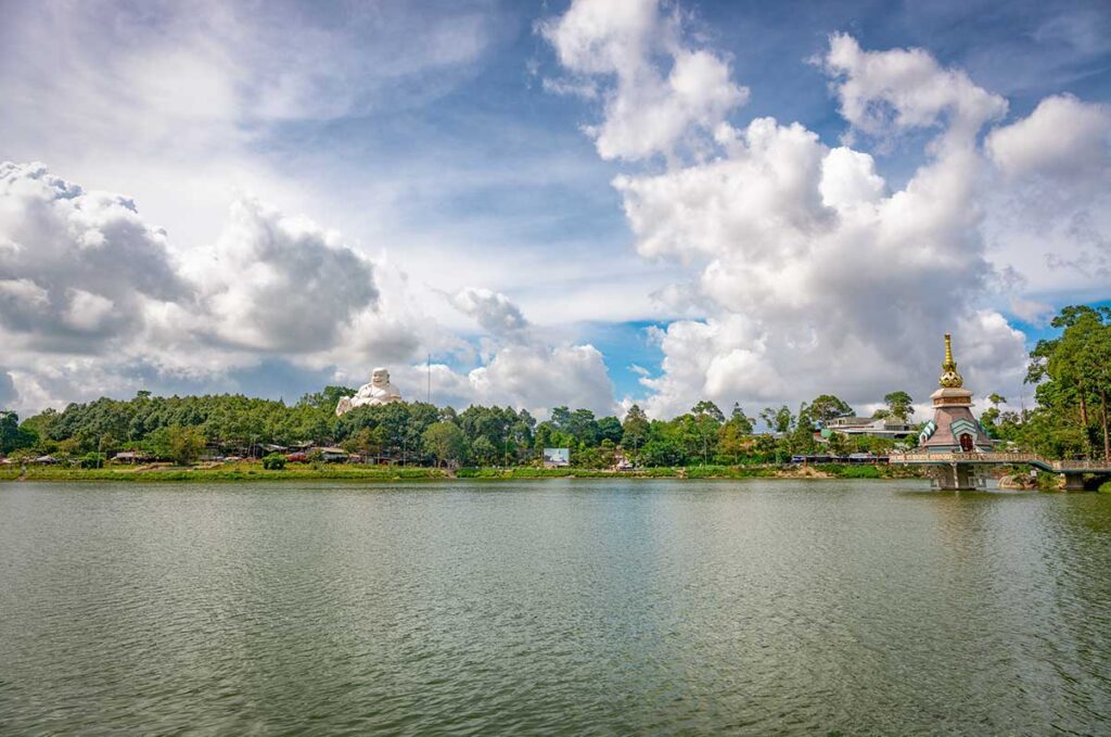 Thuy Liem Lake on Cam Mountain – Wide view of Thuy Liem Lake surrounded by pagodas and lush greenery on Forbidden Mountain.