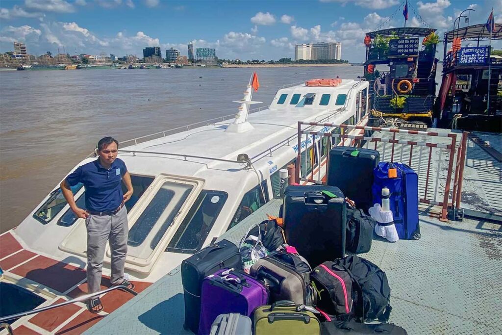 Speedboat pier at Chau Doc with luggage and passengers boarding the ferry to Phnom Penh, Cambodia.