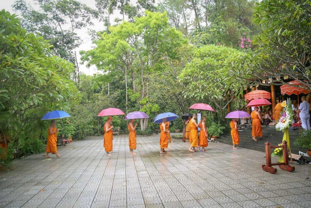 Theravada monks holding colorful umbrellas during a Buddhist ceremony at Huyen Khong Son Thuong Pagoda in Hue.